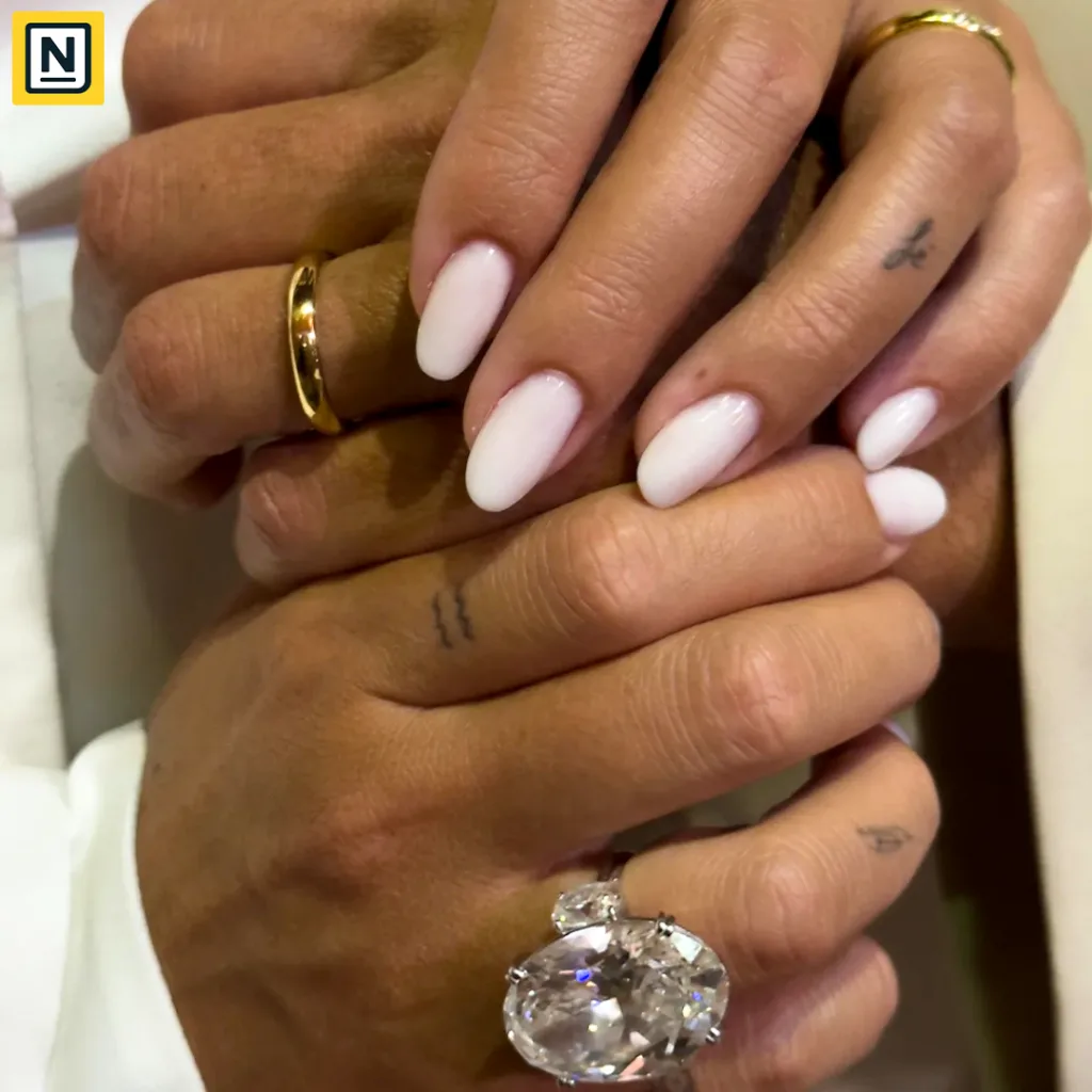 Cristiano Ronaldo and Georgina Rodríguez’s wedding rings, featuring a large oval diamond ring and elegant gold bands with white manicured nails.